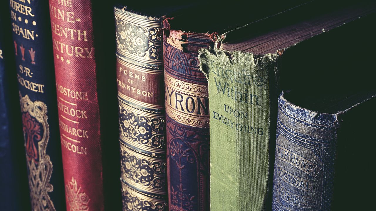 Close-up of vintage books with ornate covers, evoking knowledge and history.